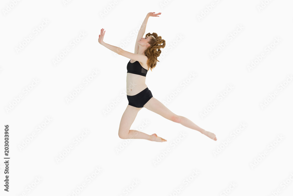 Full length of a sporty young woman jumping Full length of a sporty young woman jumping