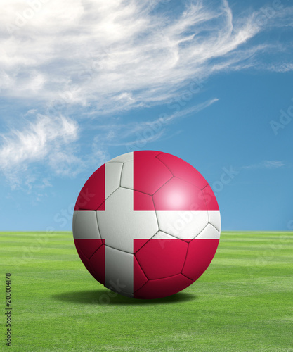 Soccer ball with Denmark flags in a green field  