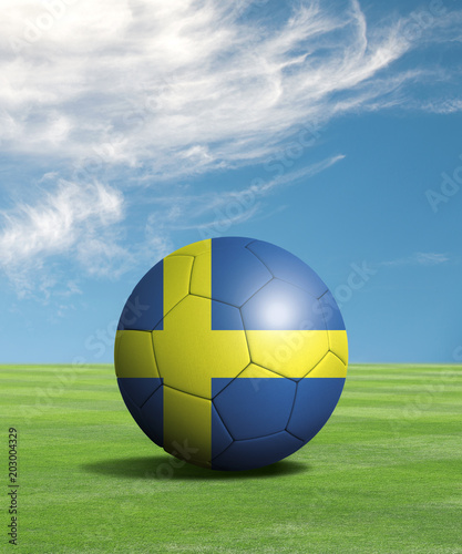 Soccer ball with Sweden flags in a green field  