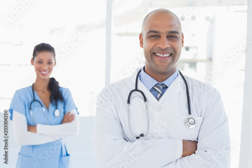 Smiling doctors looking at camera