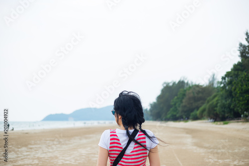 Beautiful girl relaxation on beach of sea  Rear view.