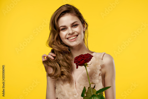 happy woman holding a scarlet rose