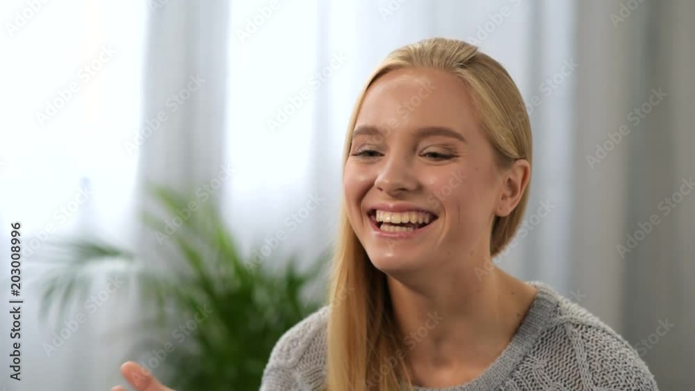 Magic device. Cheerful beautiful video blogger smiling and showing her mascara while recording a video Magic device. Cheerful beautiful video blogger smiling and showing her mascara while recording a video
