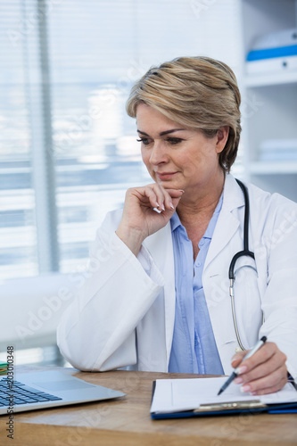 Female doctor working at her desk