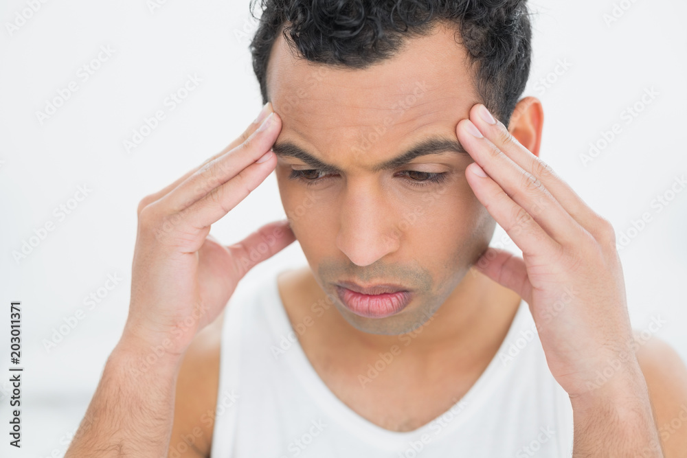 Closeup of a young man suffering from headache Closeup of a young man suffering from headache