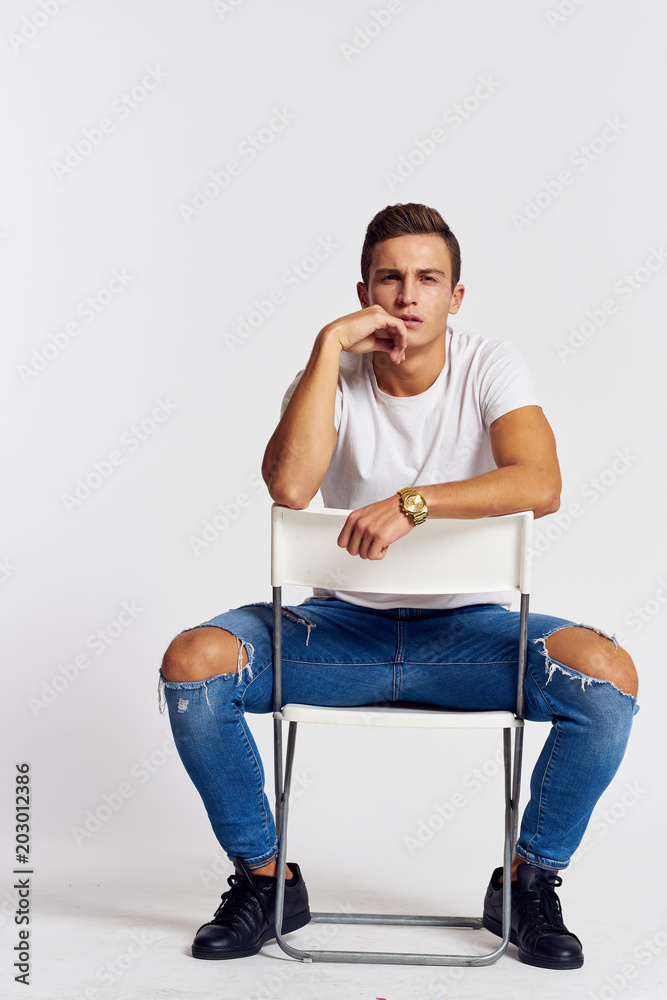 portrait of a young man sitting on a chair portrait of a young man sitting on a chair