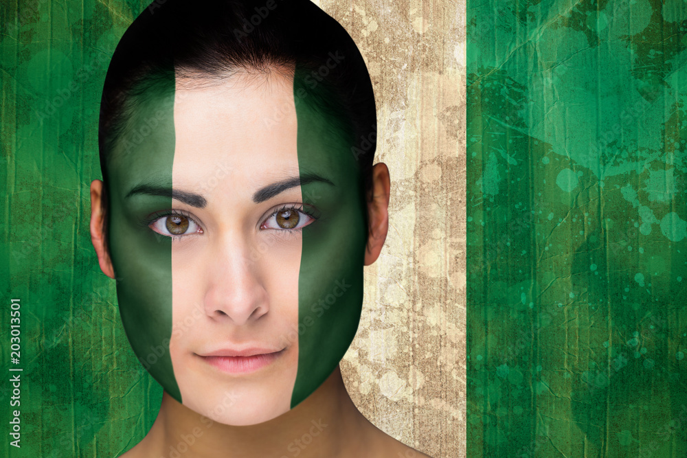 Foto Stock Composite image of beautiful football fan in face paint against  nigeria flag in grunge effect | Adobe Stock