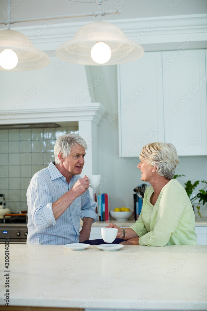 Senior couple having coffee at dining table Senior couple having coffee at dining table
