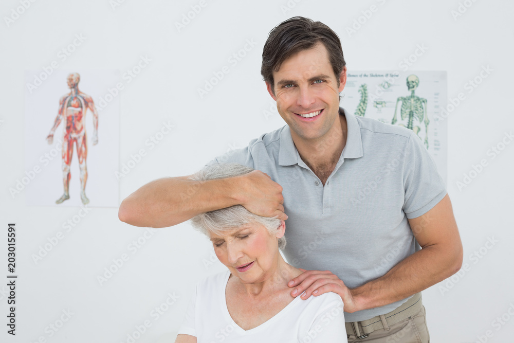 Obraz premium Senior woman getting the neck adjustment done