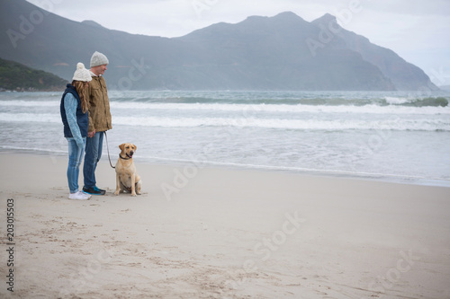 Couple standing with their pet dog
