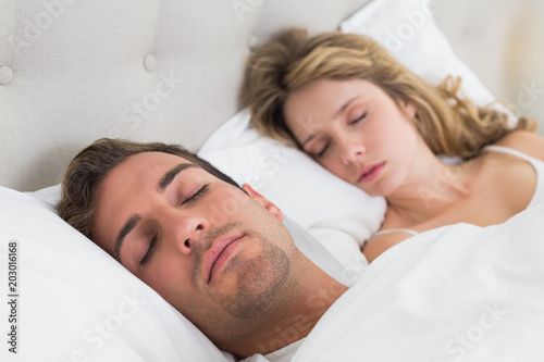 Couple sleeping together in bed