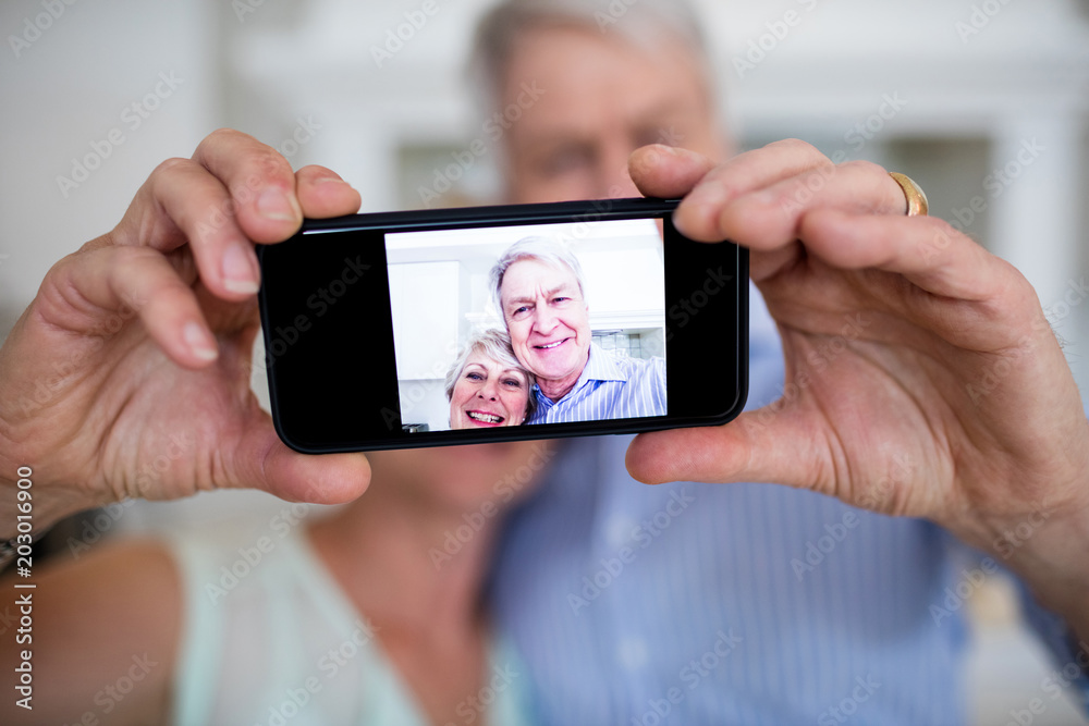 Senior couple taking selfie on mobile phone