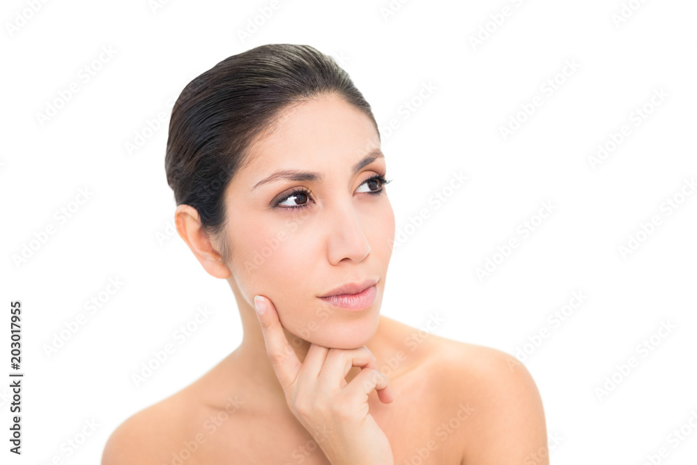Thoughtful brunette with finger on her face Thoughtful brunette with finger on her face