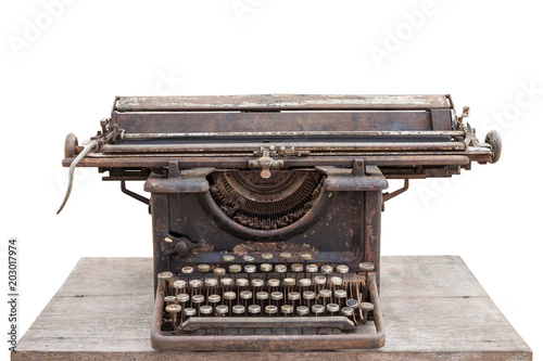 Old vintage typewriter on wooden table isolated on white background
