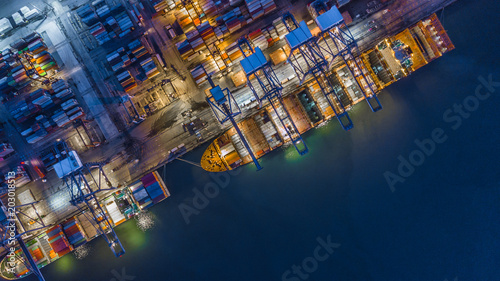 Aerial top view container cargo ship working at night, Business logistic and transportation of International by ship in the open sea.