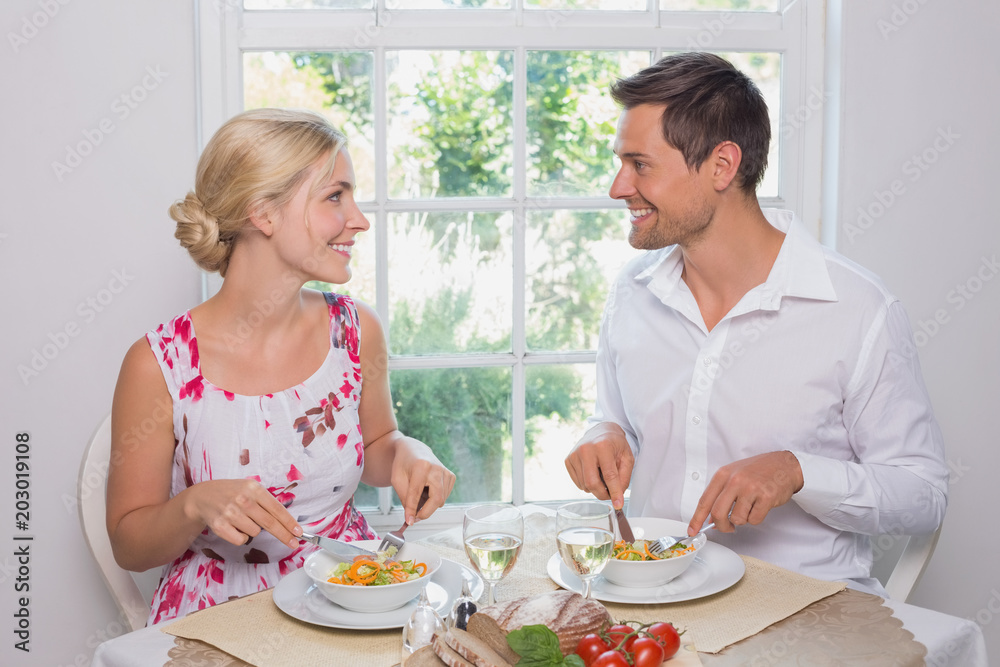 Loving couple looking at each other while having food Loving couple looking at each other while having food
