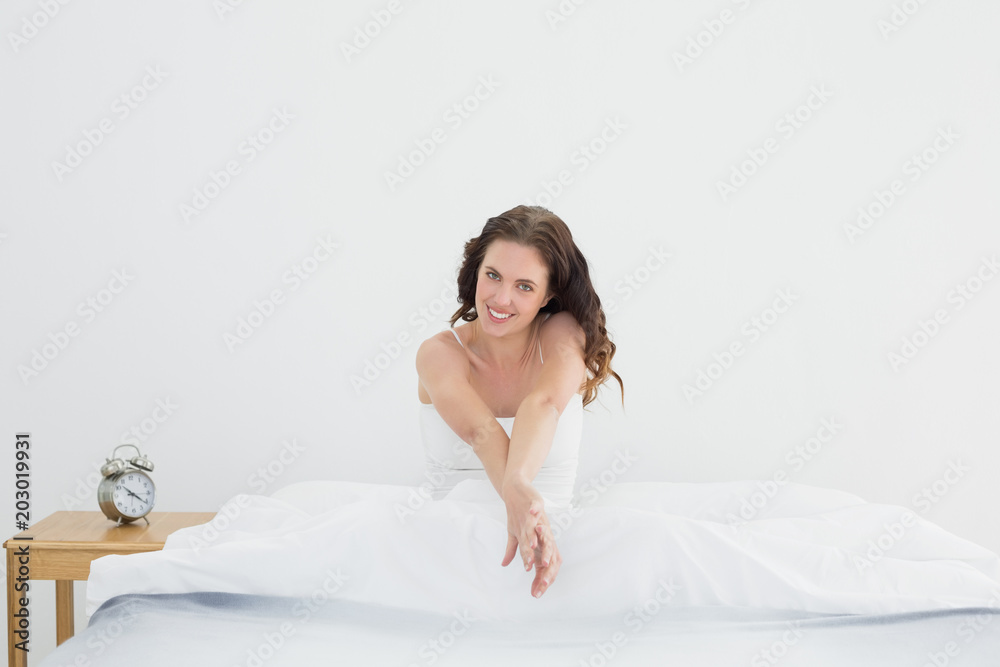 Portrait of a beautiful woman smiling in bed
