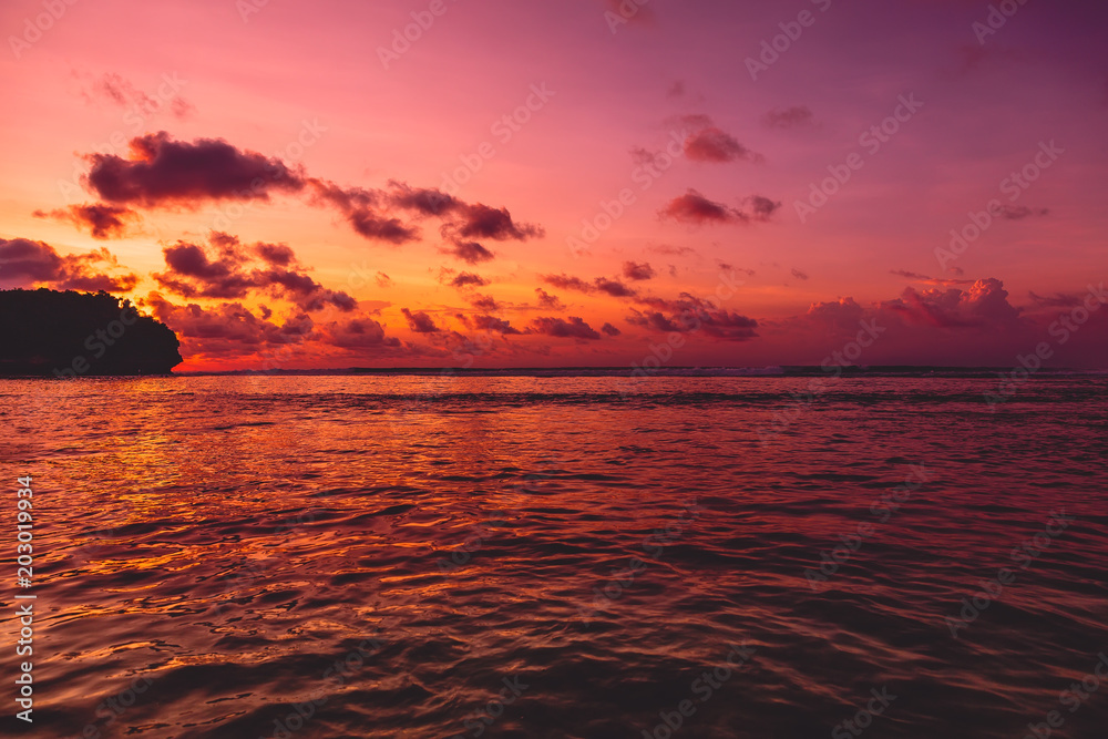 Indian ocean and sunset with clouds. Ocean with sunset colors