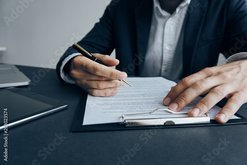 business man writes in documents