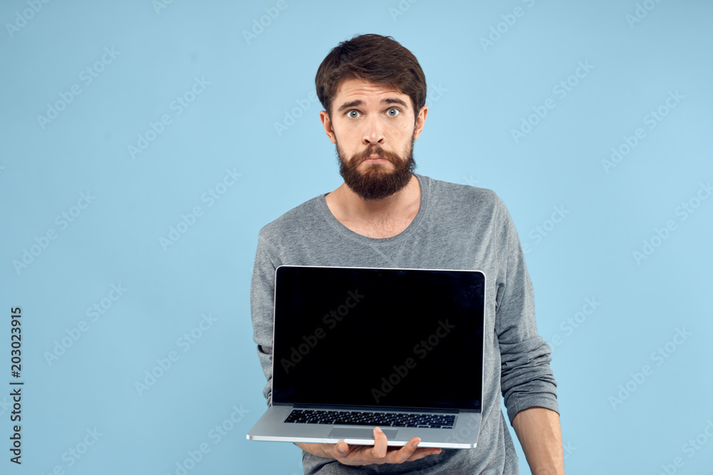 man with laptop on blue background man with laptop on blue background