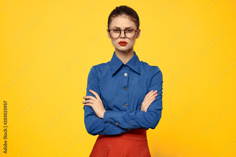 serious teacher with glasses on a yellow background serious teacher with glasses on a yellow background