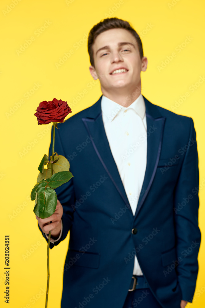 man with a rose on a yellow background man with a rose on a yellow background