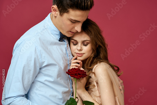 young couple on a pink background rose