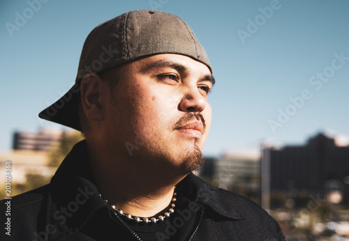 Handsome young man wearing hat backwards
