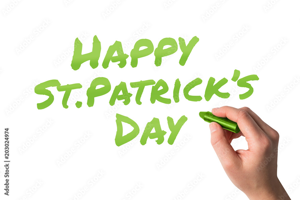 Hand holding black crayon against happy st patricks day Hand holding black crayon against happy st patricks day