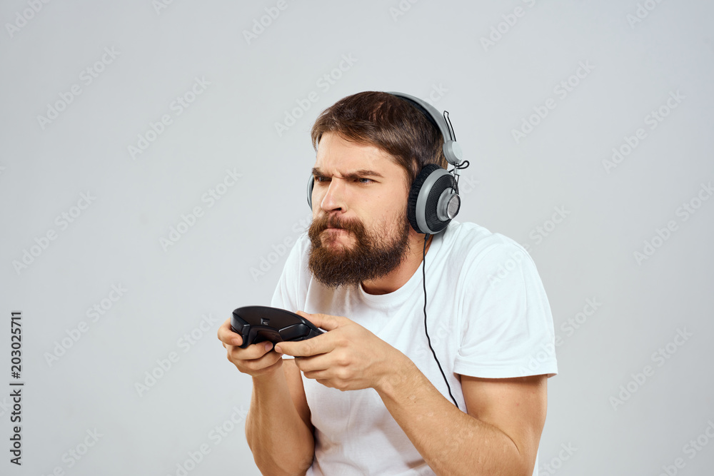 man with headphones playing console man with headphones playing console