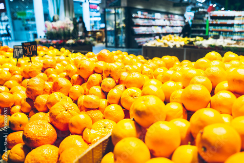 lot of oranges in store. healthy food. grocery store photo