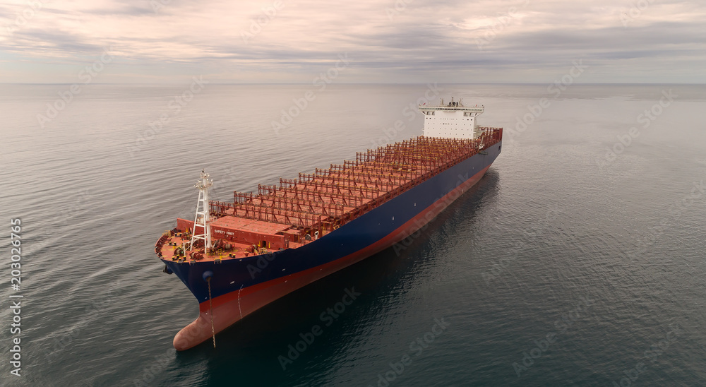 Fototapeta premium Container ship standing on the roads at anchor.