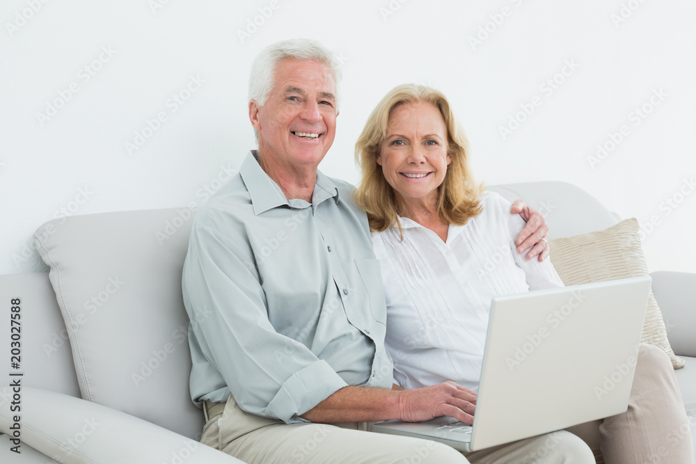Relaxed loving senior couple using laptop