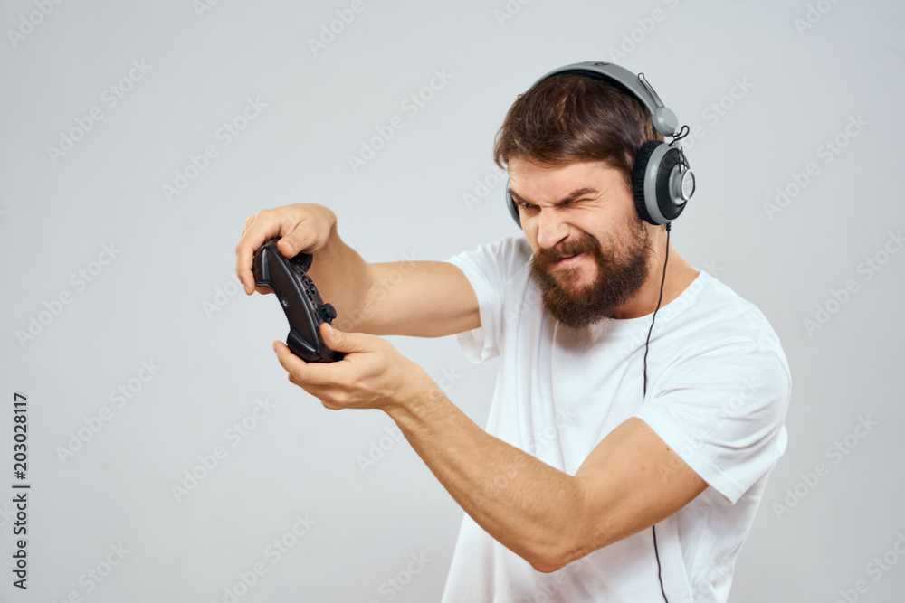man with headphones playing console man with headphones playing console