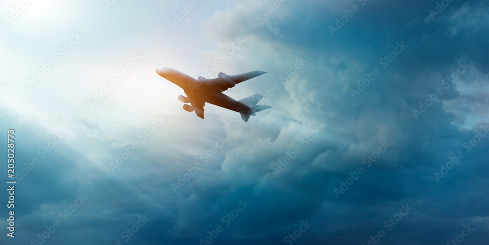 Naklejka premium Commercial airplane on the dark sky and cloud in sunrise