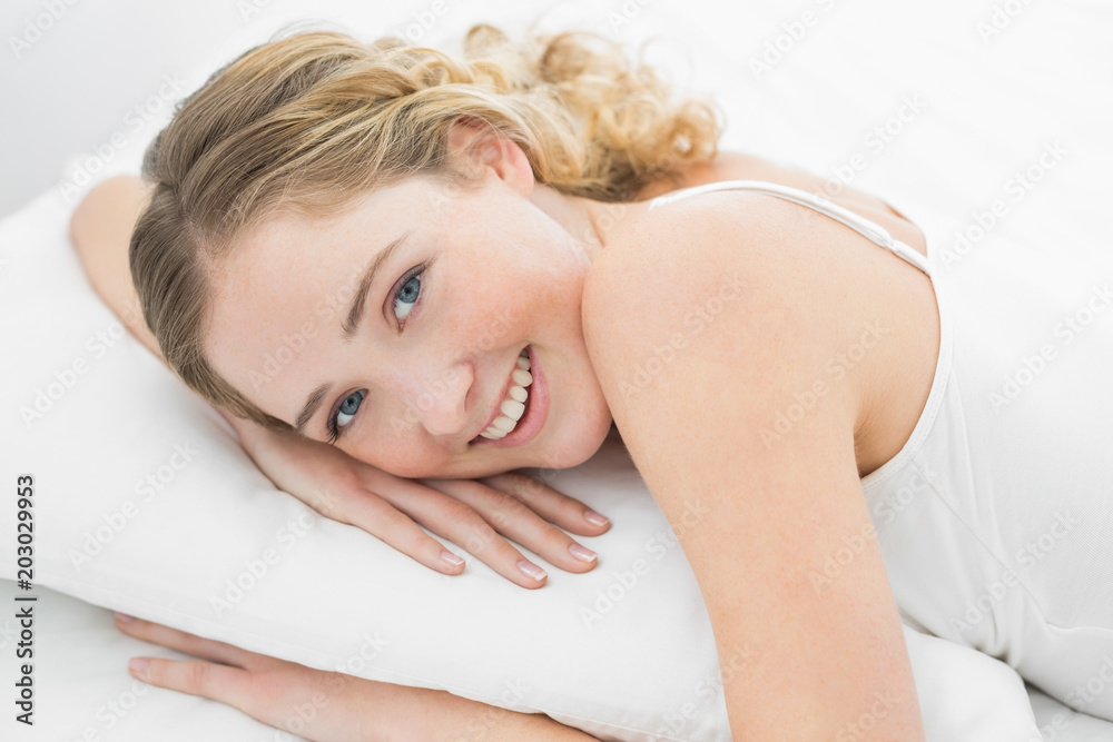 Pretty smiling blonde lying in bed Pretty smiling blonde lying in bed