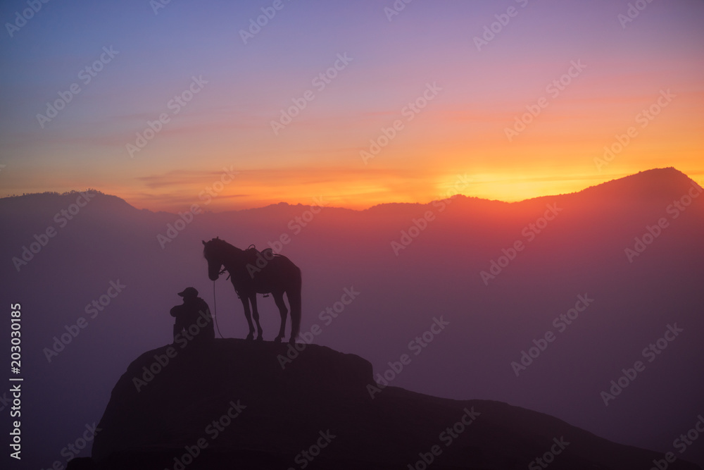Silhouette of unidentified local people or Bromo Horseman at the mountainside of Mount Bromo, Semeru, Tengger National Park, Indonesia.	