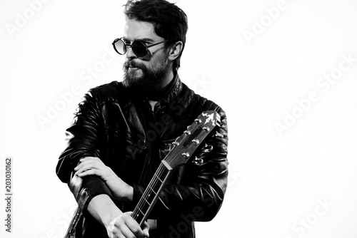 guitar player with glasses and a leather jacket