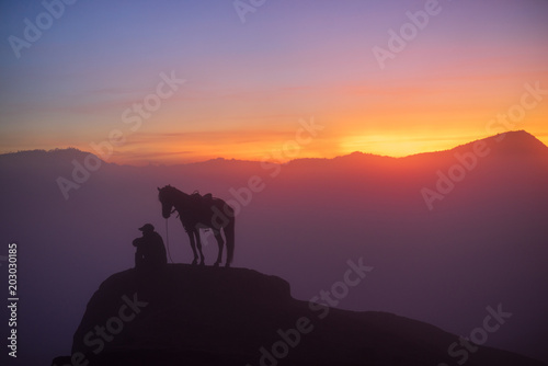 Silhouette of unidentified local people or Bromo Horseman at the mountainside of Mount Bromo  Semeru  Tengger National Park  Indonesia. 