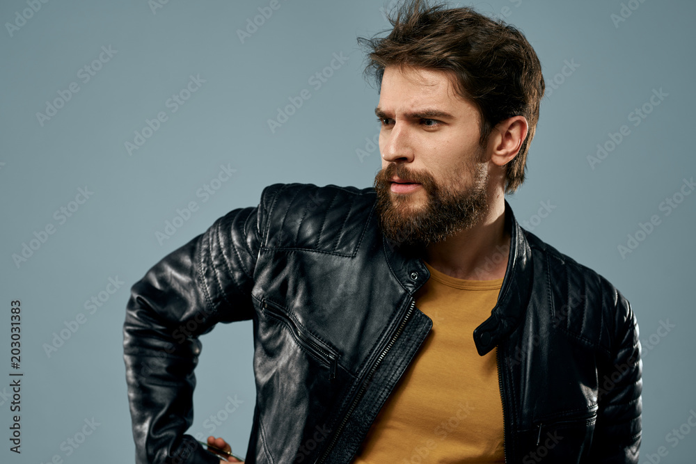 stylish man in a leather jacket and in a yellow tank top stylish man in a leather jacket and in a yellow tank top