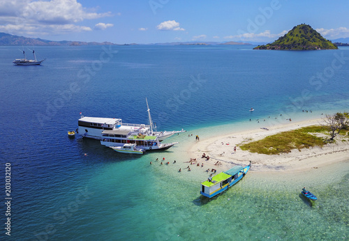 Beautiful aerial view of beaches and tourist boat sailing in Flores Island, Indonesia. photo