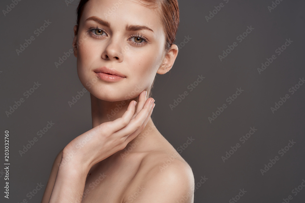 beautiful woman stroking herself in the face