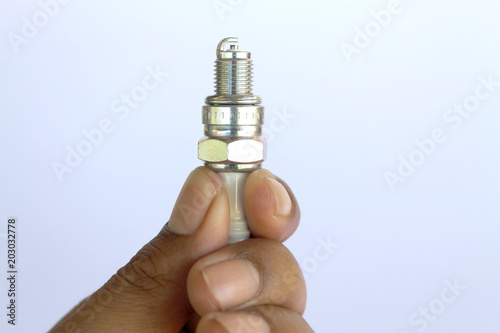 New spark plug in hand before use.