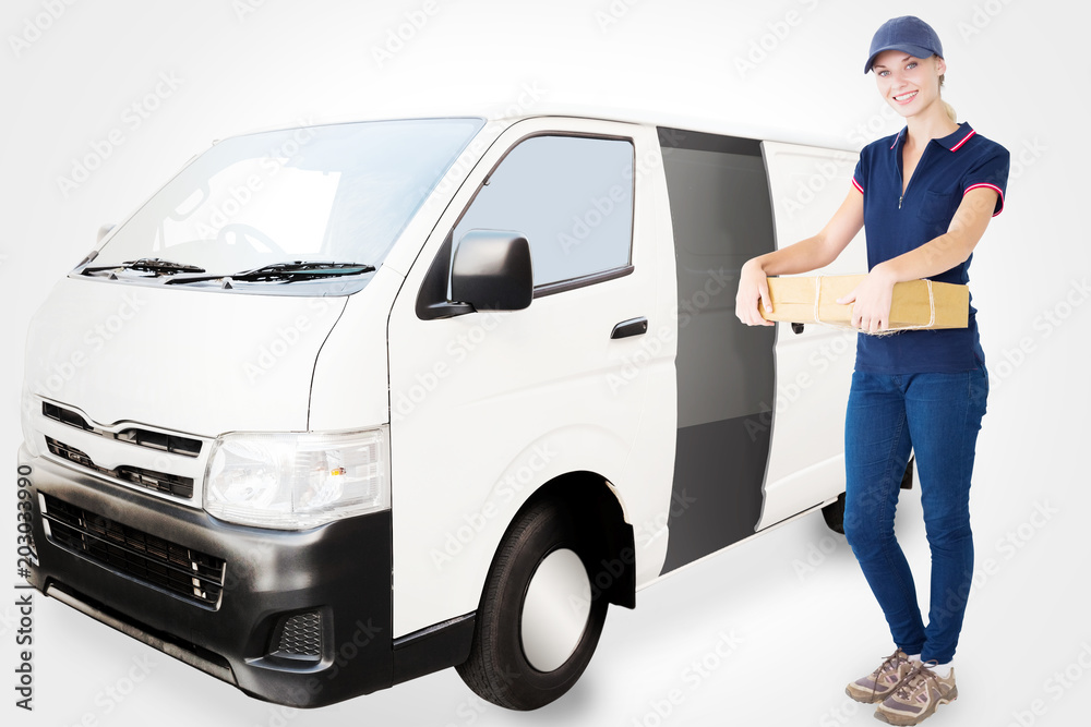Happy delivery woman holding cardboard box against white delivery van Happy delivery woman holding cardboard box against white delivery van