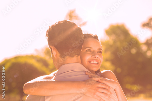 Close-up of a loving and happy woman embracing man at the park