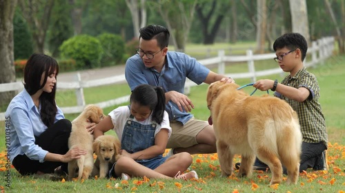 Asian family with dog puppy in park