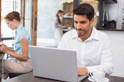 Concentrated man using laptop in coffee shop © WavebreakmediaMicro