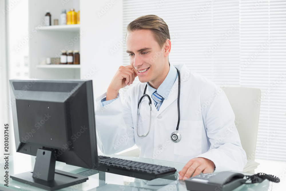 Doctor using computer at medical office Doctor using computer at medical office