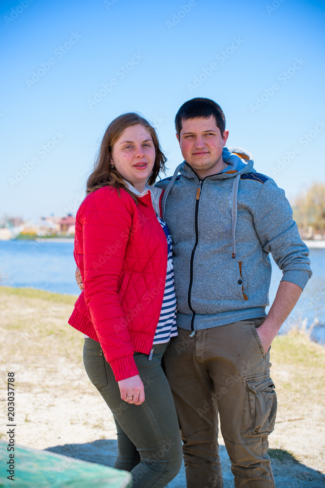 Plus size couple lovers walking in a park. Young man and woman overweight couple at vacation 