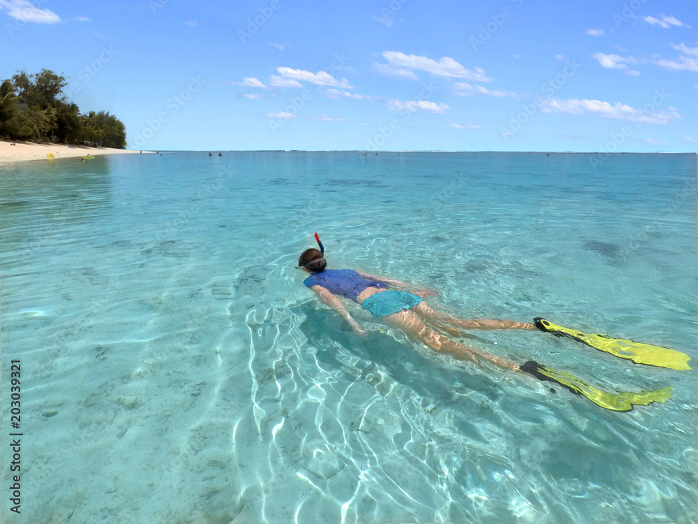 Young woman snorkelling in a lagoon in Rarotonga Cook Islands Young woman snorkelling in a lagoon in Rarotonga Cook Islands